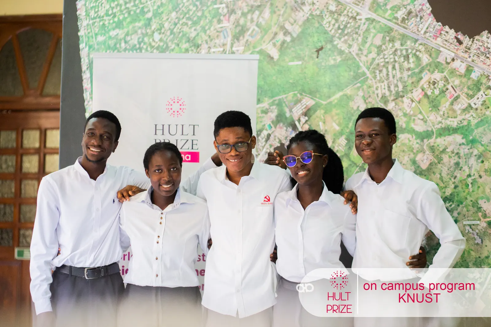The RAVen team standing together in front of a Hult Prize banner